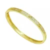 PULSERA CLAVOS CIRCONITAS DORADA